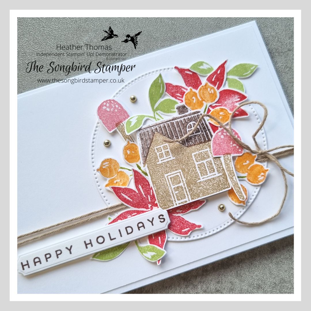 A handmade card using the Ringed with Nature stamp set from Stampin' Up! with a house, flowers and leaves in some muted Christmas colours. 