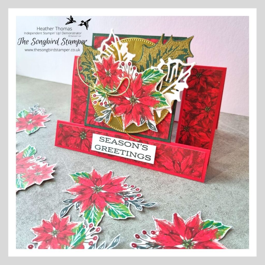 A picture of a centre step card, with poinsettias, holly leaves and gold foil, showing how to make a centre step card