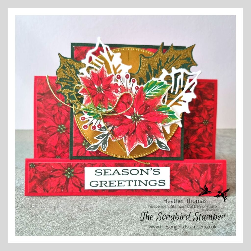A picture of a centre step card, with poinsettias, holly leaves and gold foil.