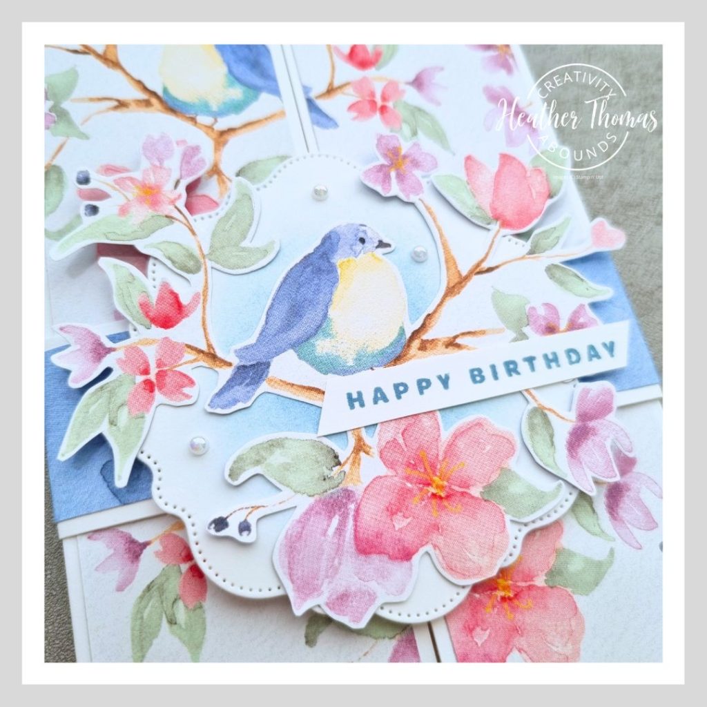 A close up of an easy gatefold card with the belly band and gorgeous bird design.