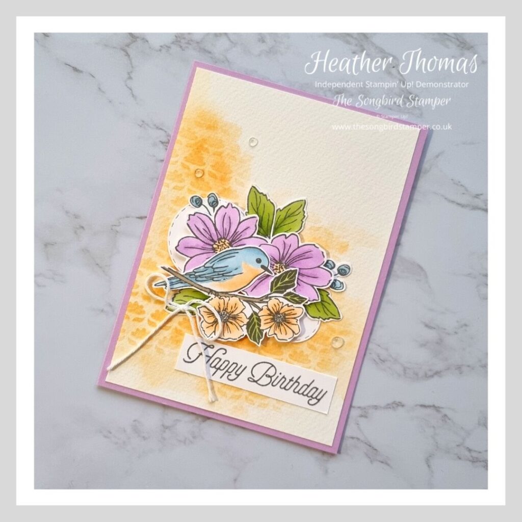A handmade card with birds and flowers showing the difference between stamping with black ink or grey ink