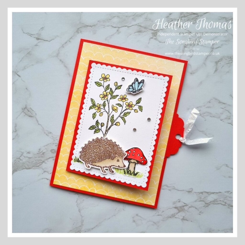The outside of my pull tab card, in red and yellow with a hedgehog, mushroom and a tree.