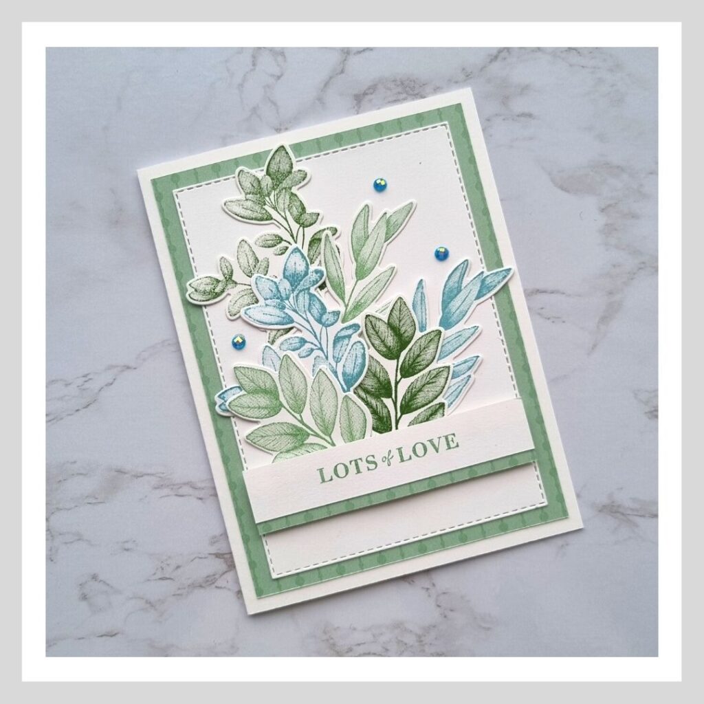 A simple and stylish card with leaves stamped in greens and blues.