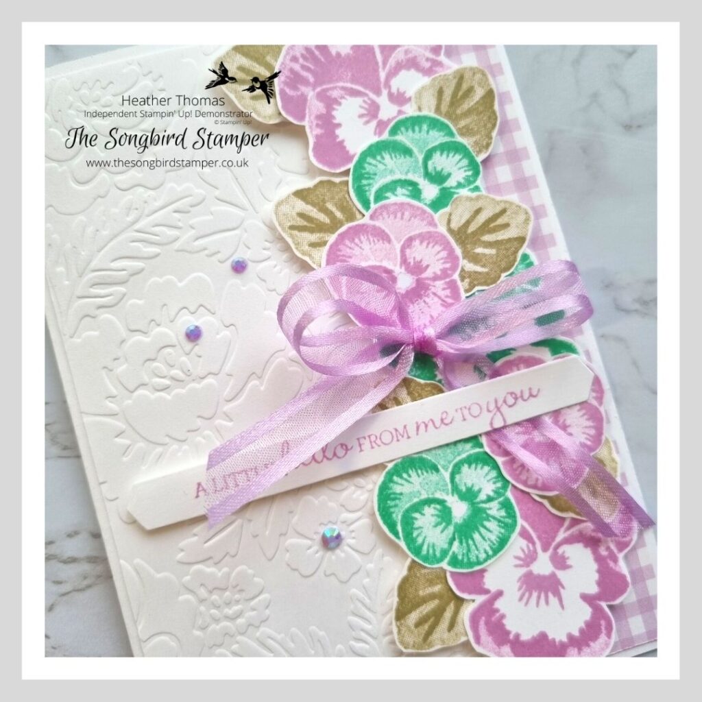 A pretty handmade card using the subtle embossing folder trick with flowers in purple and teal.