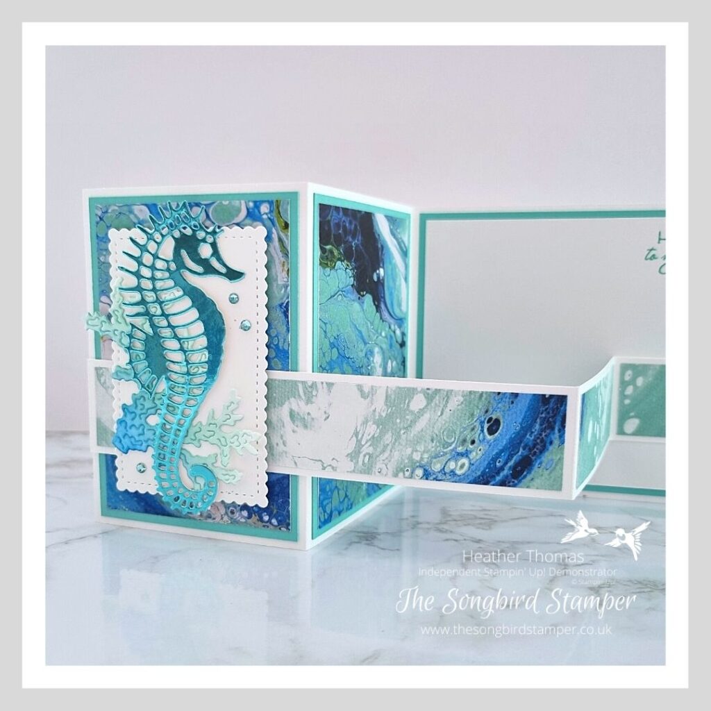 A close up of a masculine z-fold card in blues and greens with a gorgeous seahorse on the front. 
