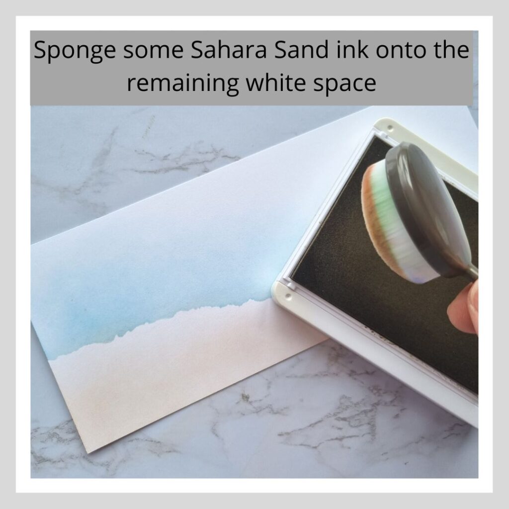 Step two of three step by step instructions on how to create a beach scene. Text says "Sponge some Sahara Sand ink onto the remaining white space"