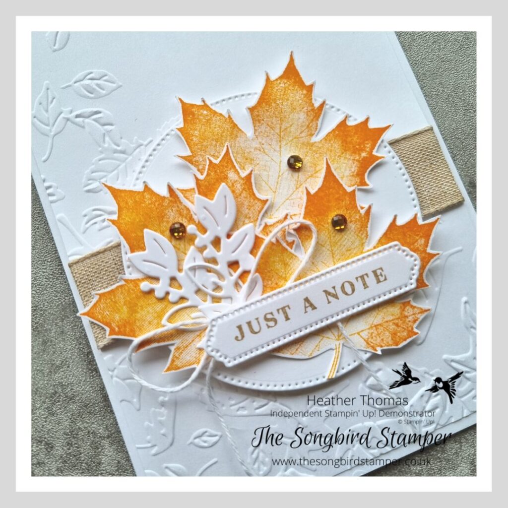a handmade card in white and orange with stamped leaves, the end result of the two tone autumn leaves technique