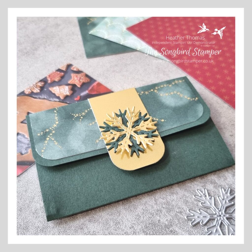 A magnetic gift card holder made in dark green card with foil accents.