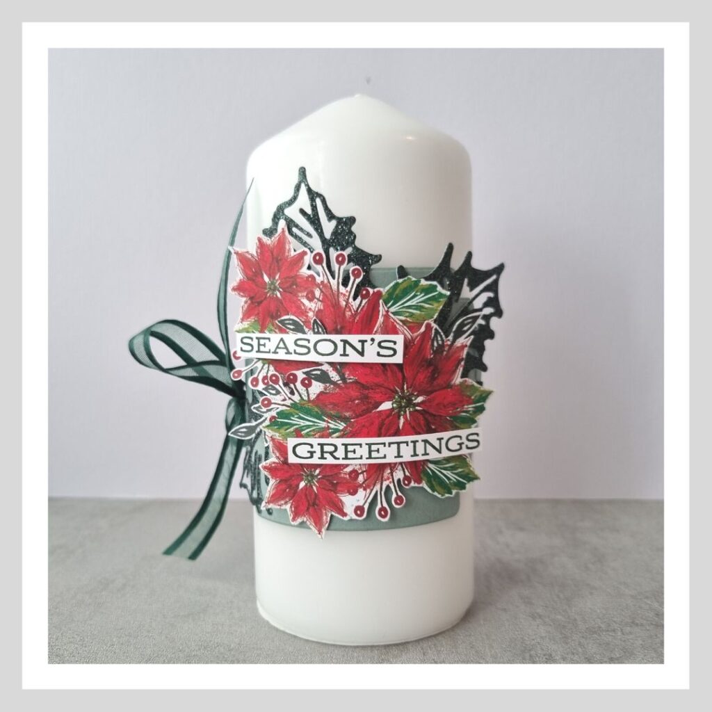 One of my decorated Christmas Candles, using the Boughs of Holly suite from Stampin' Up! Poinsettia flowers and green holly leaves