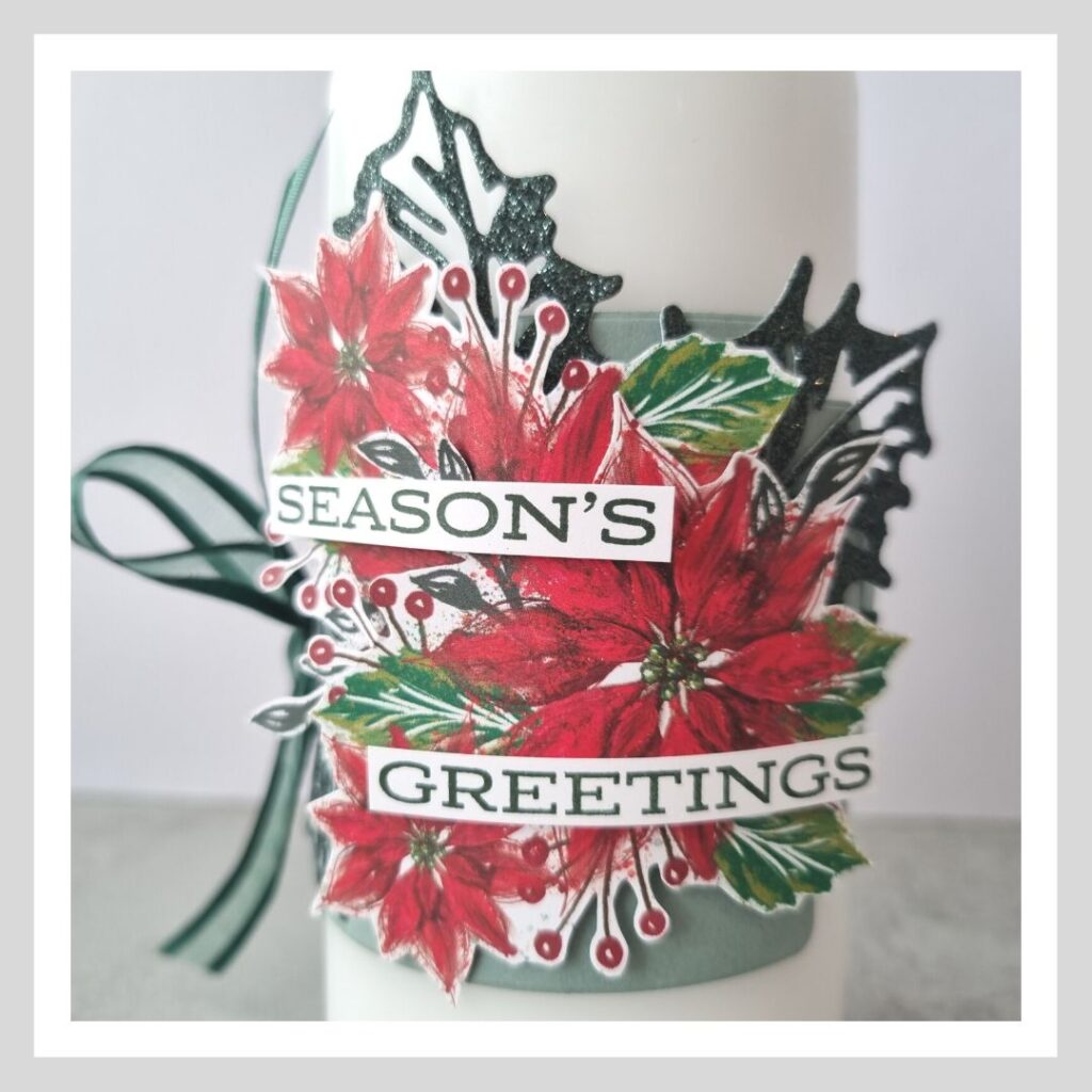 One of my decorated Christmas Candles, using the Boughs of Holly suite from Stampin' Up! Poinsettia flowers and green holly leaves