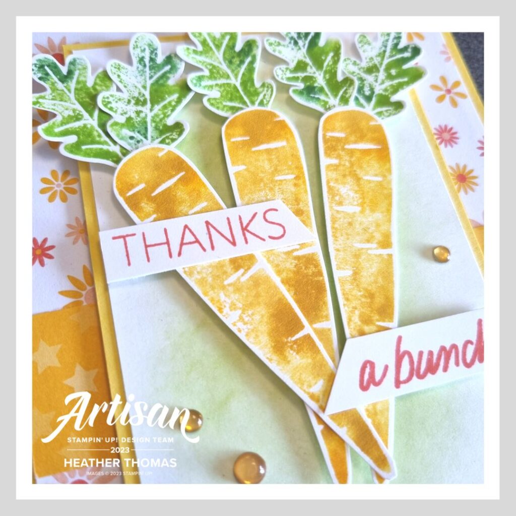 A bright and vibrant handmade card with three carrots stamped using the baby-wipe technique and the words 'thanks a bunch'