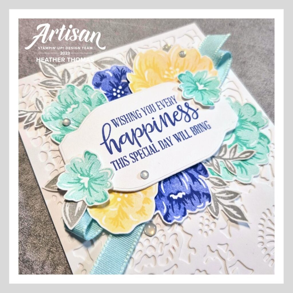 A handmade birthday card with flowers in yellows and blues, using the two-tone flora stamp set from Stampin' Up!