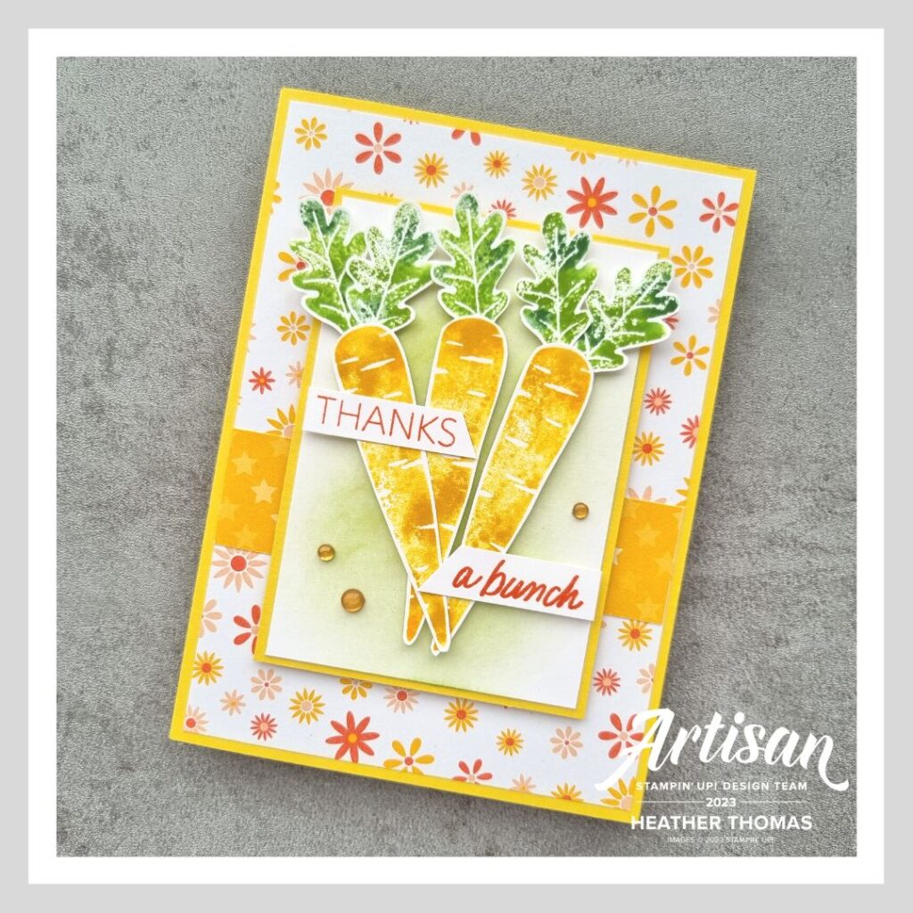 A bright and vibrant handmade card with three carrots stamped using the baby-wipe technique and the words 'thanks a bunch'