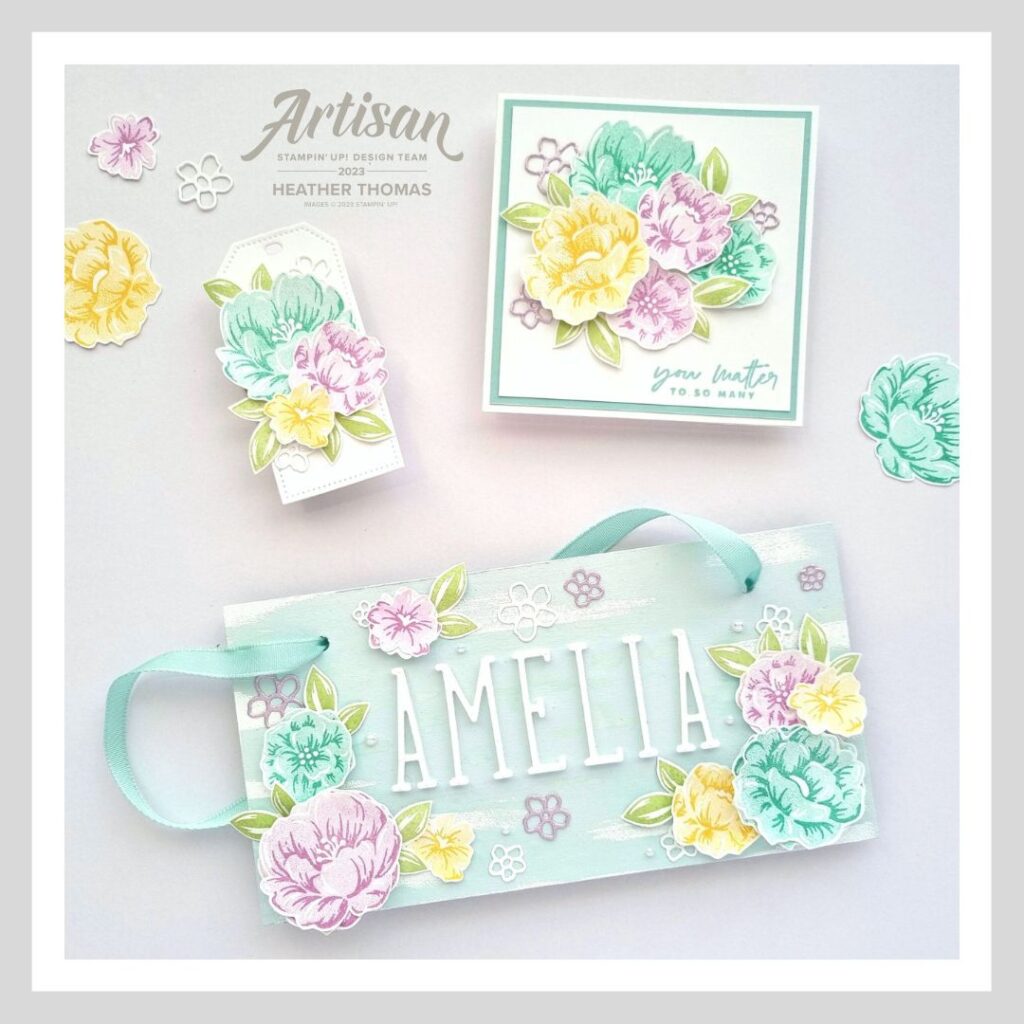 A picture of a gift set, including a Two-Tone Flora home decor piece, a matching card and gift tag, in light spring colours.