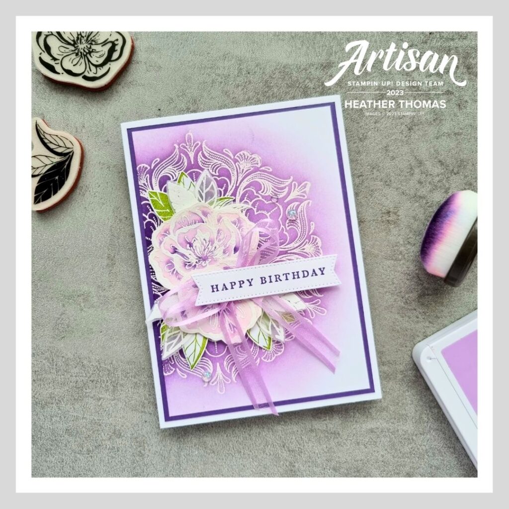 A handmade card in purple, with flowers, demonstrating the emboss resist technique