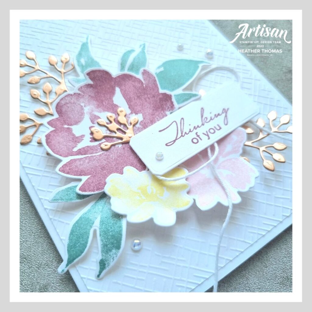 An elegant embossed handmade card with flowers and a sentiment that says 'thinking of you'