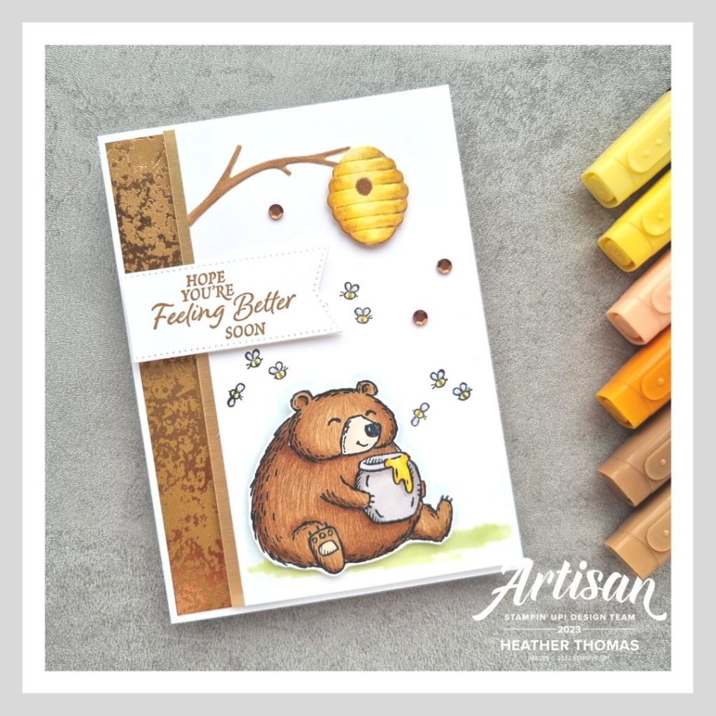 A handmade card with a bear holding a pot of honey underneath a tree, demonstrating how to colour fur with alcohol markers