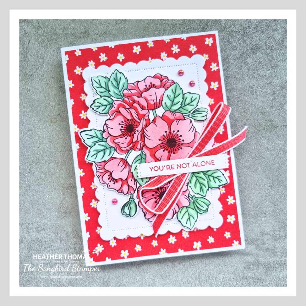 My sweet sorbet flower card, made with Stampin' Up! craft products, with a red paper background and a large flower and leaf image coloured in reds and blue/greens