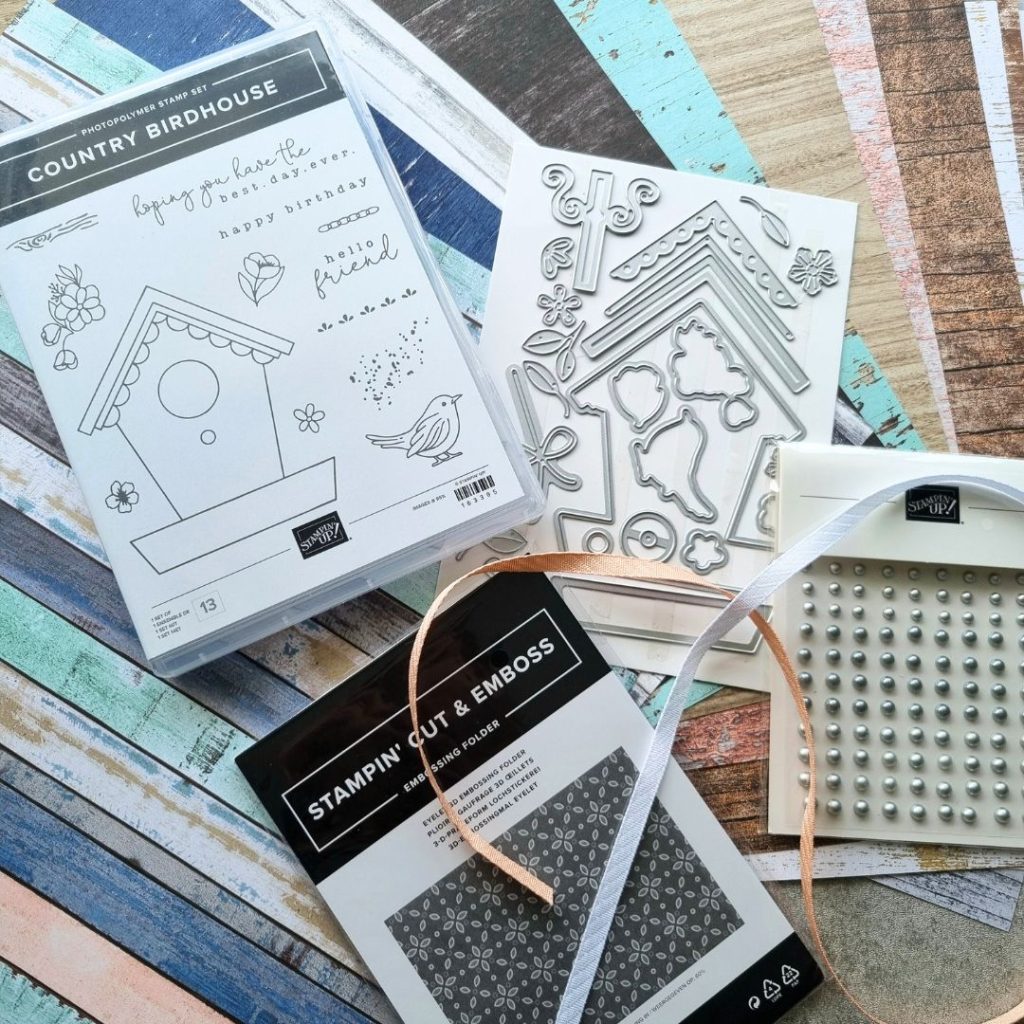 The Country Birdhouse bundle with associated products from Stampin' Up! There is a stamp set, a die set, some lovely wood patterned paper, silver gems and an embossing folder called Eyelet.